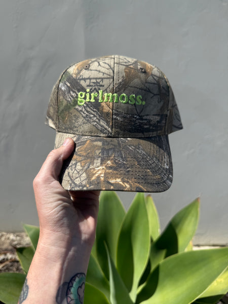 Girlmoss unstructured on camo dad hat with lime green thread.