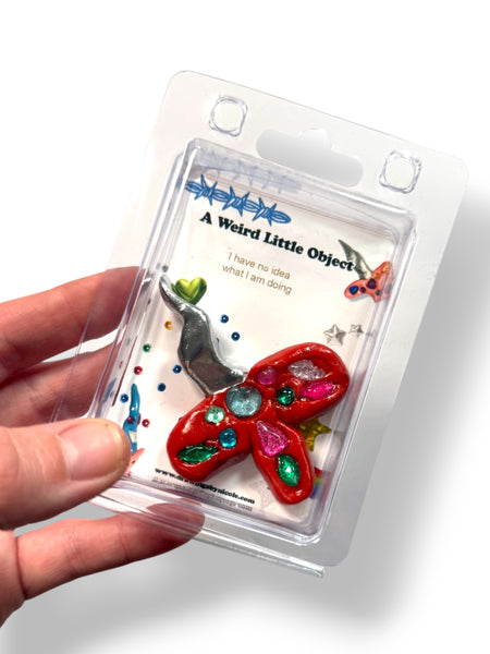 A Weird Little Object 1, red and silver sword