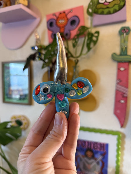 Imperfect sword wall hanging (blue and silver), A Weird Little Object, clay and gloss