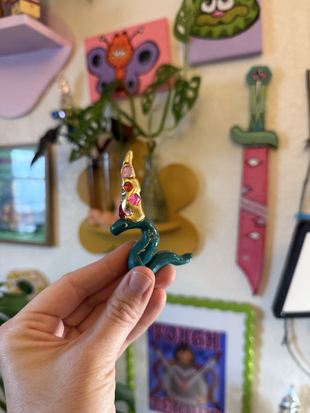 A cursed imperfect wizard snake yikes (green and gold), A Weird Little Object, clay and gloss