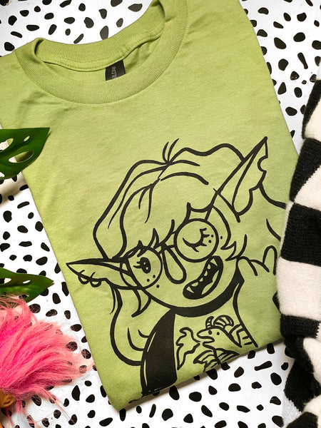 Orc girl on avocado green unisex shirt. Printed in Long Beach, CA.