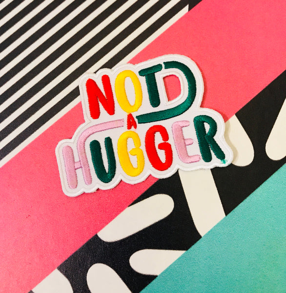 Not a Hugger 4 inch iron on patch, designed by latenightcrew AU.